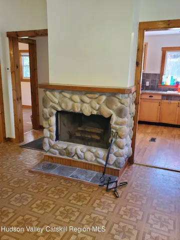 a living room with a fireplace windows and a table