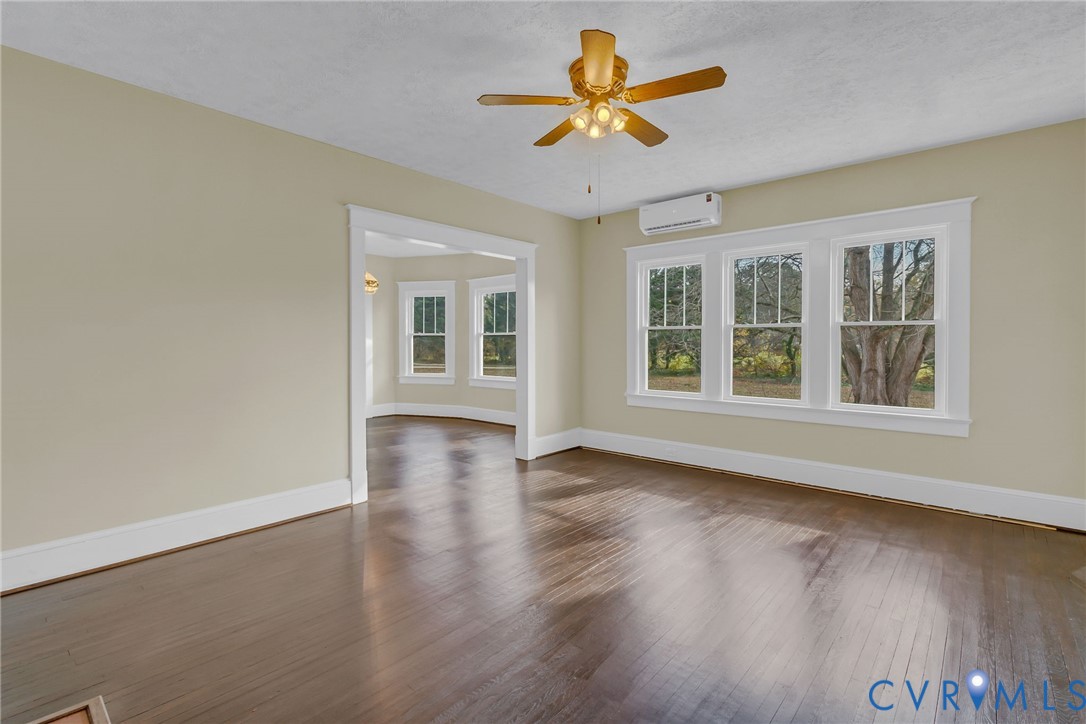 109 Courthouse Road Heathsville, VA 22473 - Photo 4 of 50 an empty room with wooden floor and windows