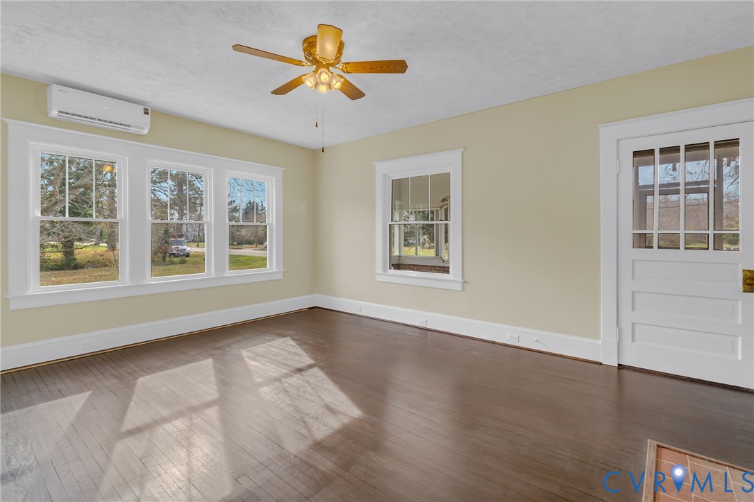 109 Courthouse Road Heathsville, VA 22473 - Photo 5 of 50 a view of an empty room with a window and wooden floor