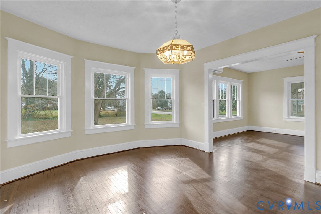 109 Courthouse Road Heathsville, VA 22473 - Photo 9 of 50 a view of an empty room with wooden floor and a window