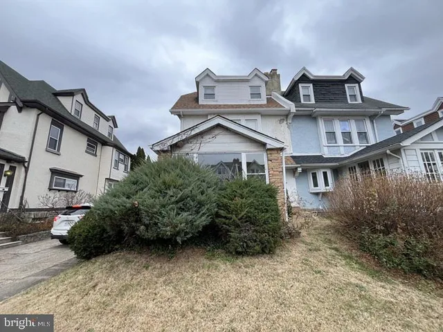 a view of a house with roof and plants
