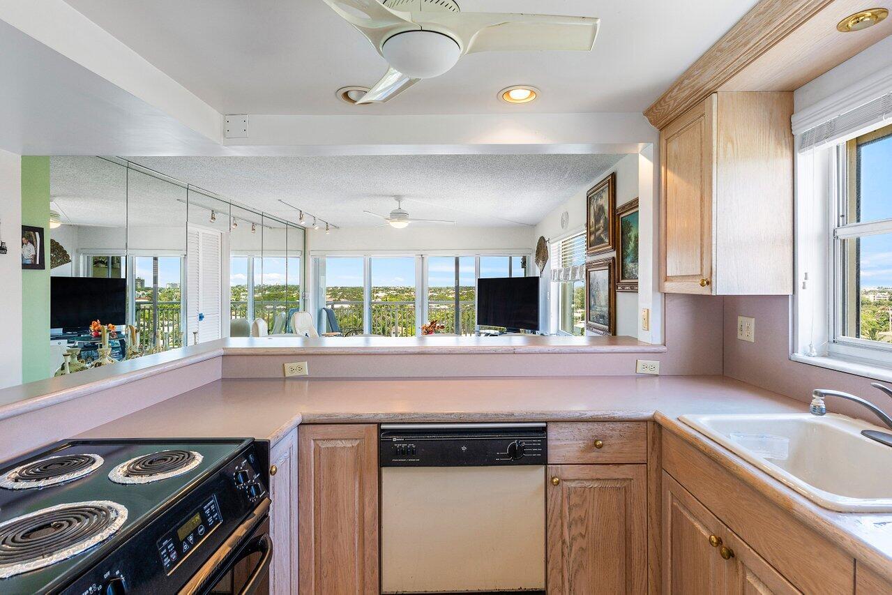 2611 North Riverside Drive, Unit 908 Pompano Beach, FL 33062 - Photo 15 of 43 a kitchen with a stove and a sink