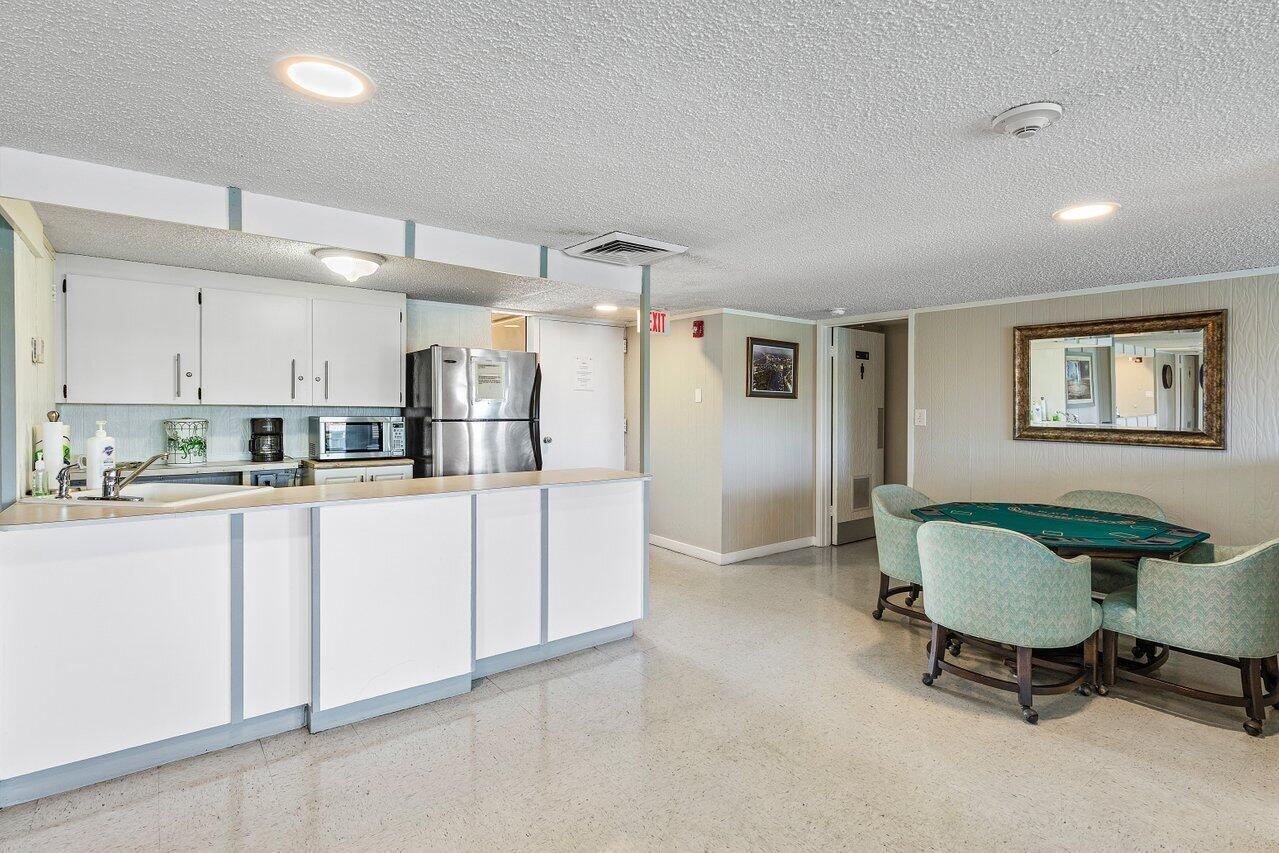 2611 North Riverside Drive, Unit 908 Pompano Beach, FL 33062 - Photo 39 of 43 a kitchen with stainless steel appliances a refrigerator and cabinets