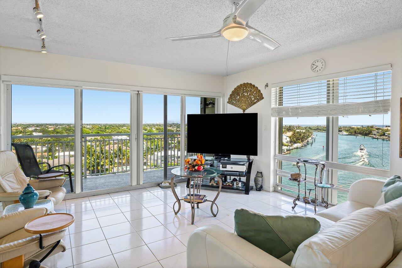2611 North Riverside Drive, Unit 908 Pompano Beach, FL 33062 - Photo 8 of 43 a living room with furniture a floor to ceiling window and a flat screen tv