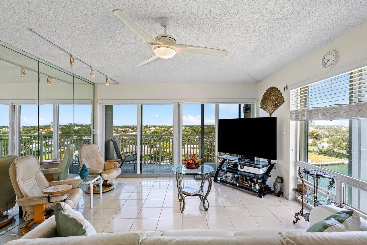 2611 North Riverside Drive, Unit 908 Pompano Beach, FL 33062 - Photo 9 of 43 a living room with furniture and a flat screen tv