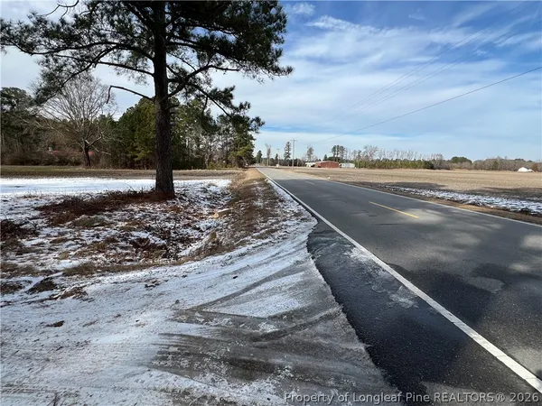 a view of a yard with wooden fence