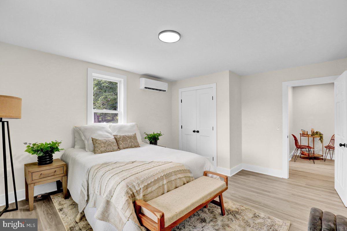 1069 Rawlinsville Road Willow Street, PA 17584 - Photo 12 of 47 a bedroom with a bed and wooden floor