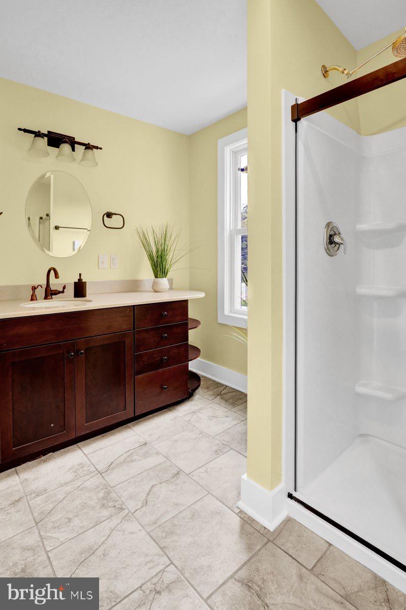 1069 Rawlinsville Road Willow Street, PA 17584 - Photo 14 of 47 a bathroom with a tub sink and mirror
