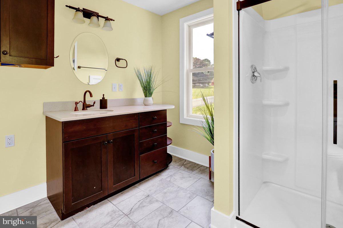 1069 Rawlinsville Road Willow Street, PA 17584 - Photo 16 of 47 a bathroom with a sink a mirror and a bathtub