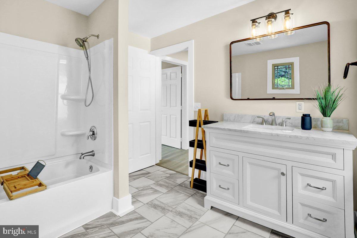1069 Rawlinsville Road Willow Street, PA 17584 - Photo 20 of 47 a bathroom with a tub sink and mirror