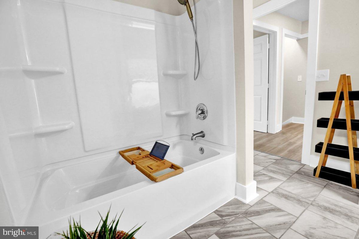 1069 Rawlinsville Road Willow Street, PA 17584 - Photo 22 of 47 a bathroom with a tub shower and a sink