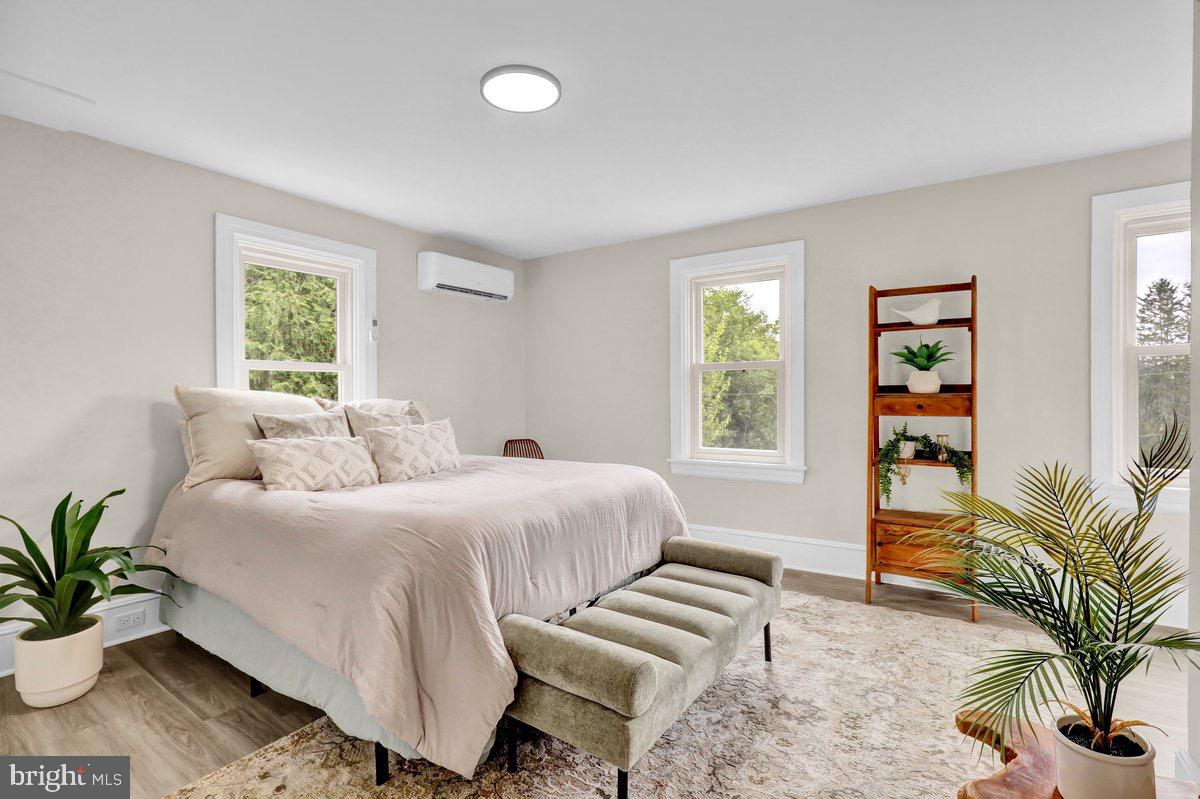 1069 Rawlinsville Road Willow Street, PA 17584 - Photo 26 of 47 a bedroom with a large bed and a potted plant