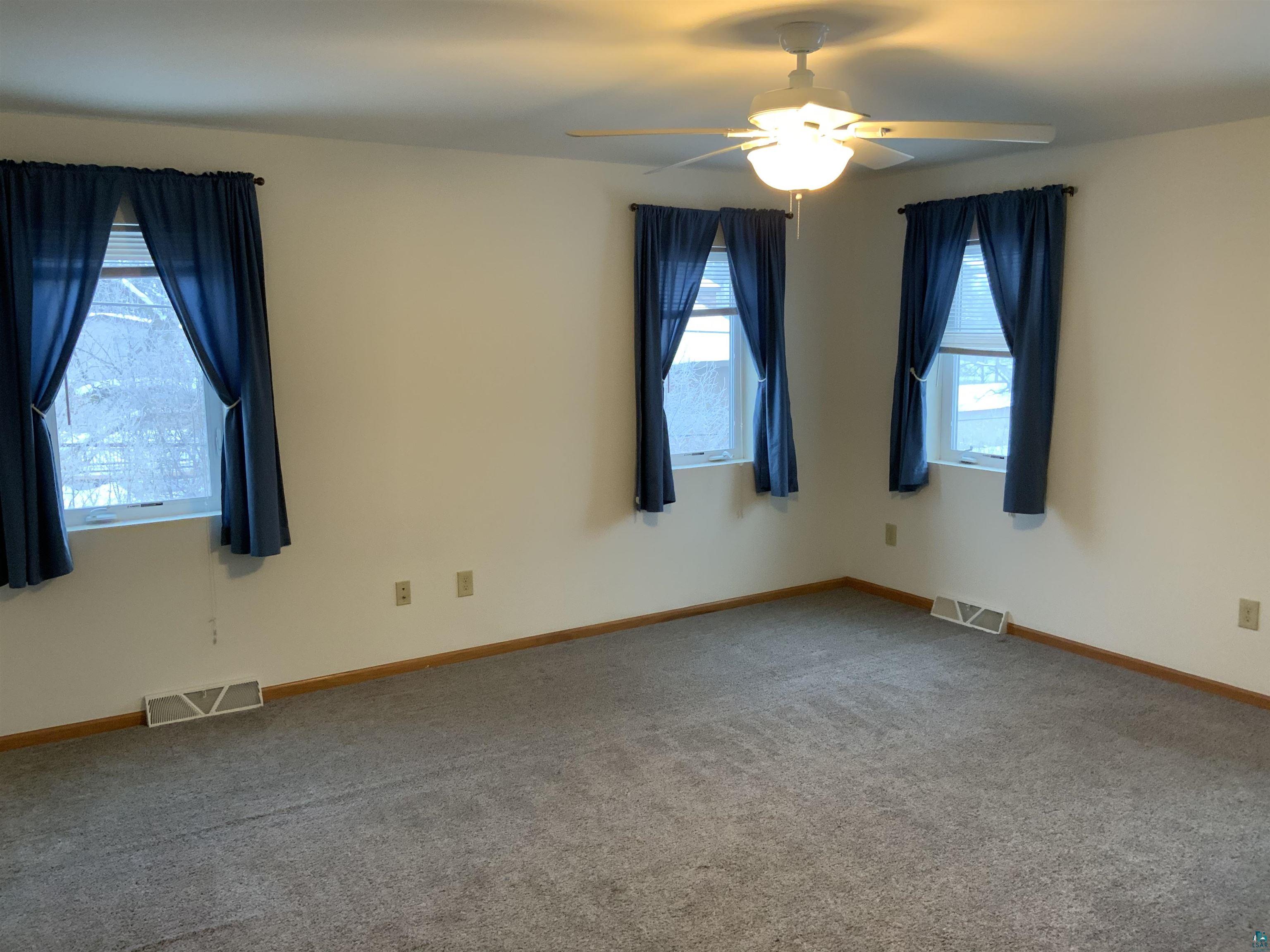 904 Spring Lake Road Cloquet, MN 55720 - Photo 9 of 14 Carpeted empty room with ceiling fan