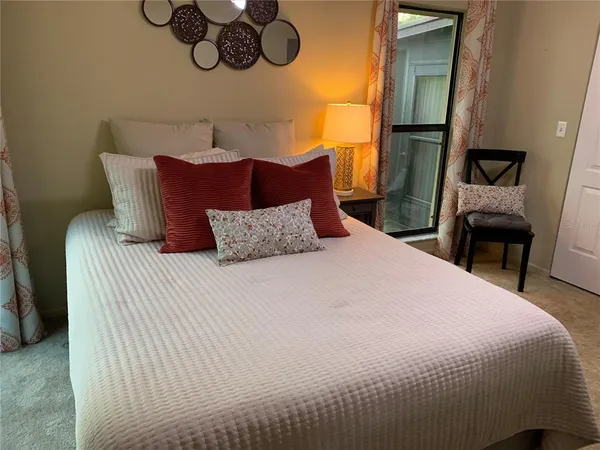 a bedroom with a bed and dresser with mirror