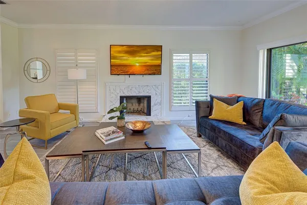a living room with furniture and a fireplace