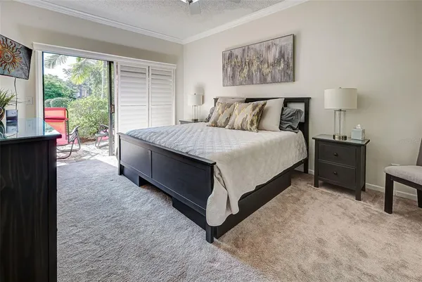 a spacious bedroom with a bed and glass window
