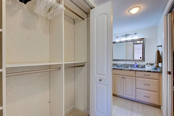 a bathroom with a granite countertop sink a mirror and a bathtub