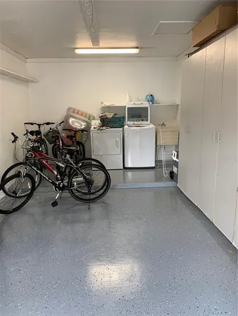 a view of a storage and utility room with washer and dryer