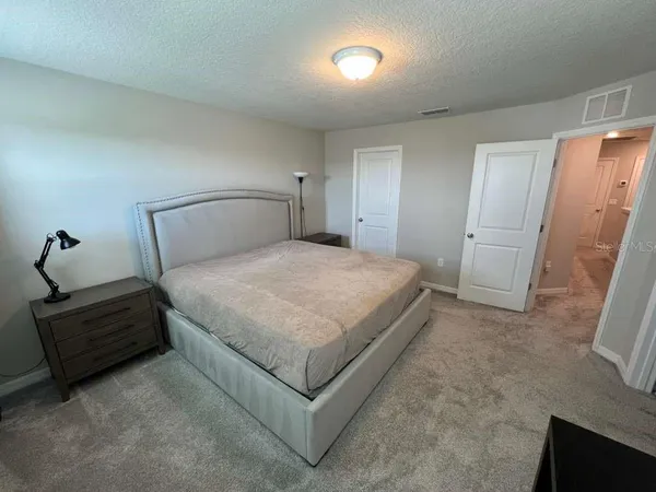 a bathroom with a granite countertop sink a mirror and shower