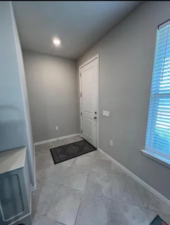 a view of an empty room with a fireplace