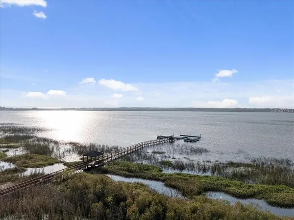 a view of a terrace with lawn chairs and wooden floor