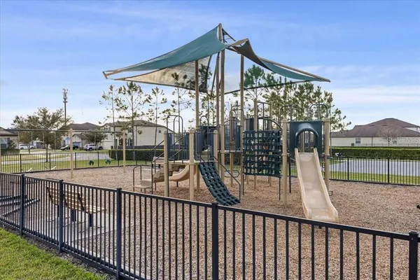 a view of a patio with dining table and chairs with wooden floor