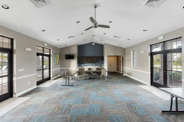 a front view of a house with a garden and trees