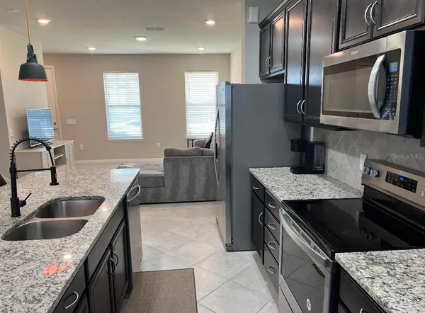 a kitchen that has a sink and a stove