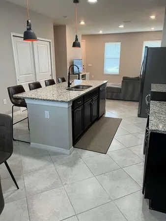 a kitchen with a sink a counter top space and a mirror