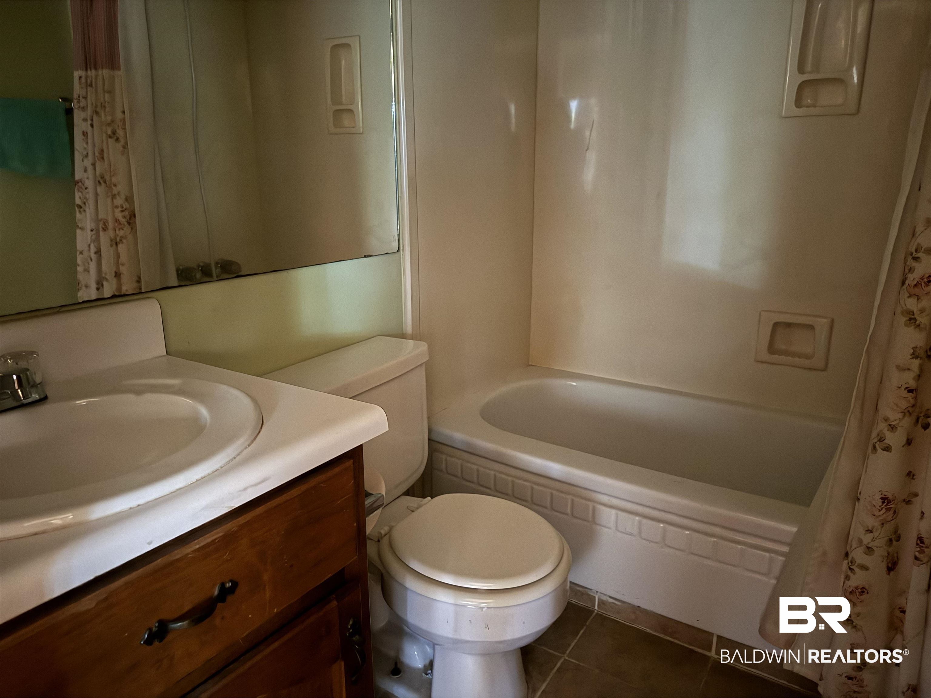 1909 Brill Road Mobile, AL 36605 - Photo 10 of 15 Full bath featuring vanity, dark tile patterned flooring, and shower / bath combo