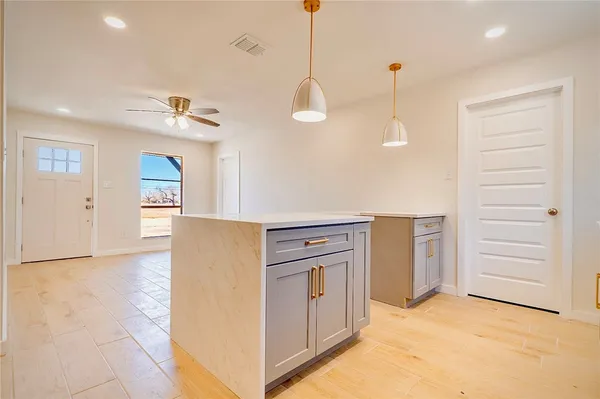 a view of a kitchen with furniture and an empty room