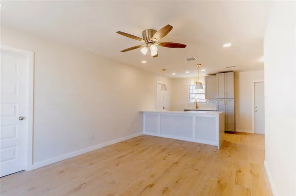 a kitchen with stainless steel appliances kitchen island granite countertop a refrigerator a sink and a stove