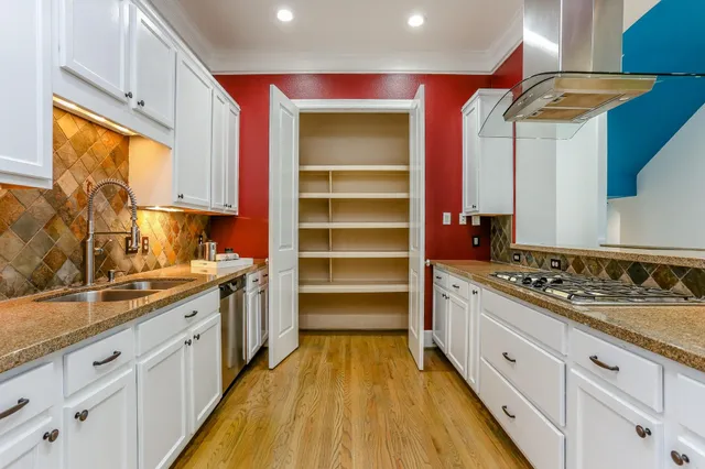 a kitchen with cabinets oven and a sink