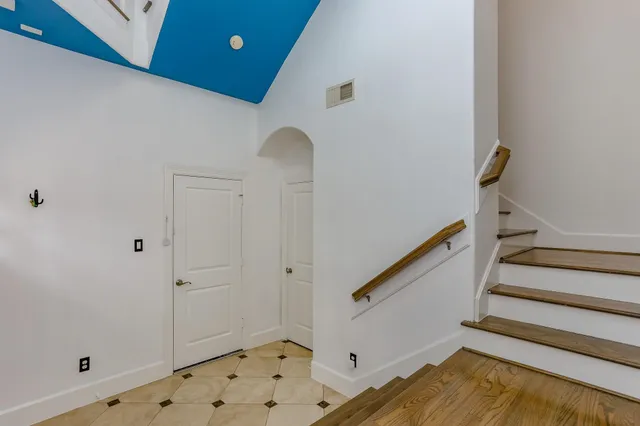 a view of entryway with stairs and wooden floor