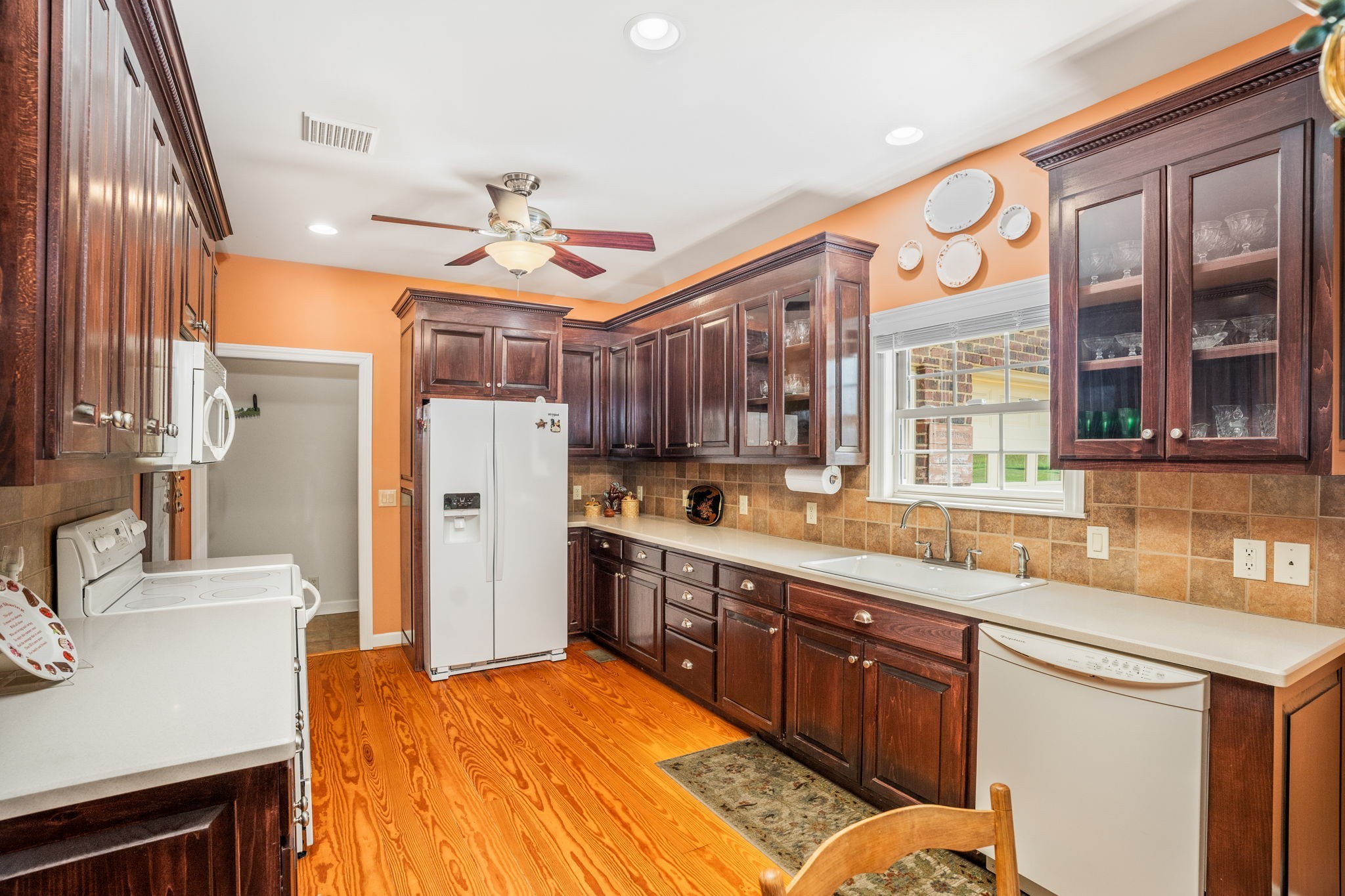 4313 South Garrett Road Springfield, TN 37172 - Photo 23 of 69 a large kitchen with stainless steel appliances granite countertop a refrigerator a sink dishwasher a dining table and chairs with wooden floor