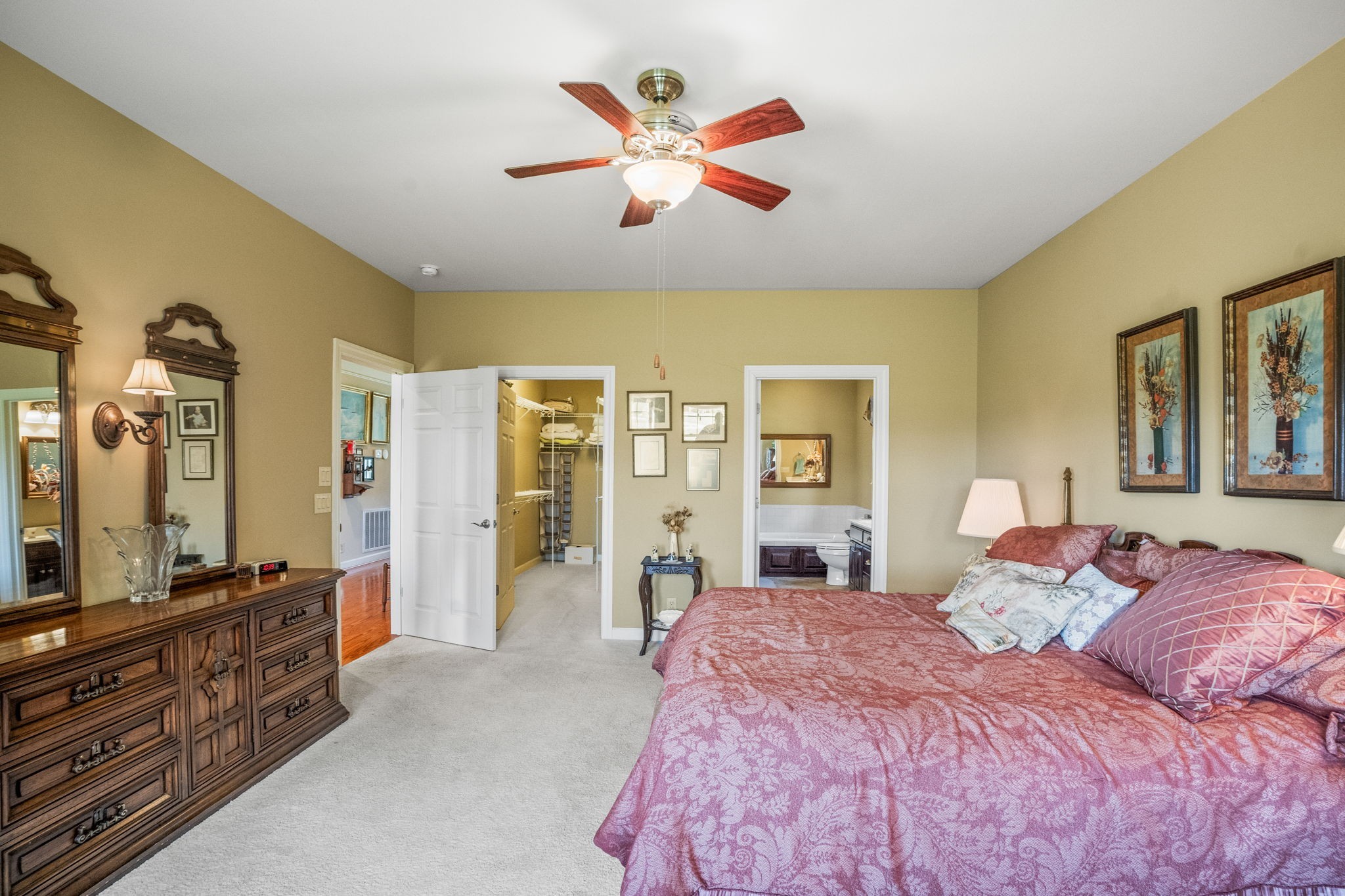 4313 South Garrett Road Springfield, TN 37172 - Photo 8 of 69 a bedroom with a large bed and a chandelier