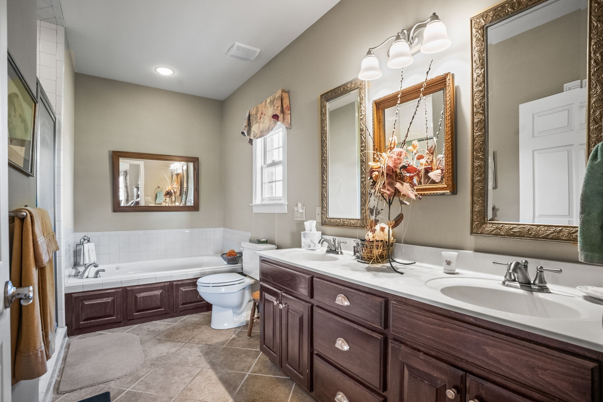 4313 South Garrett Road Springfield, TN 37172 - Photo 9 of 69 a spacious bathroom with a double vanity sink a large mirror and a bathtub