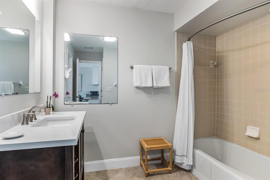 5850 Gasparilla Road, Unit M4 Boca Grande, FL 33921 - Photo 13 of 36 a bathroom with a sink a toilet and a mirror
