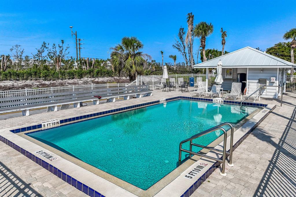 5850 Gasparilla Road, Unit M4 Boca Grande, FL 33921 - Photo 15 of 36 a view of a swimming pool with chairs