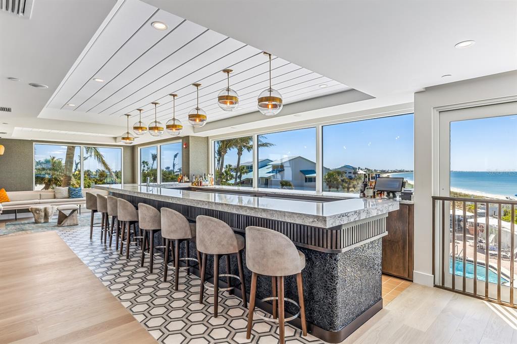 5850 Gasparilla Road, Unit M4 Boca Grande, FL 33921 - Photo 19 of 36 a dining hall with furniture a window and kitchen view