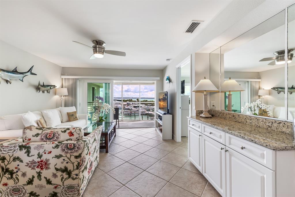 5850 Gasparilla Road, Unit M4 Boca Grande, FL 33921 - Photo 7 of 36 a large living room with stainless steel appliances kitchen island granite countertop furniture and a kitchen view