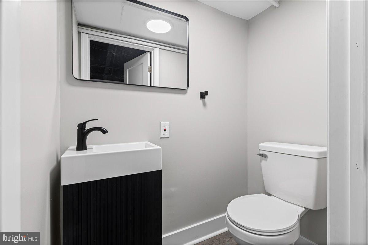 6629 Ross Street Philadelphia, PA 19119 - Photo 22 of 26 a white toilet sitting next to a bathroom sink