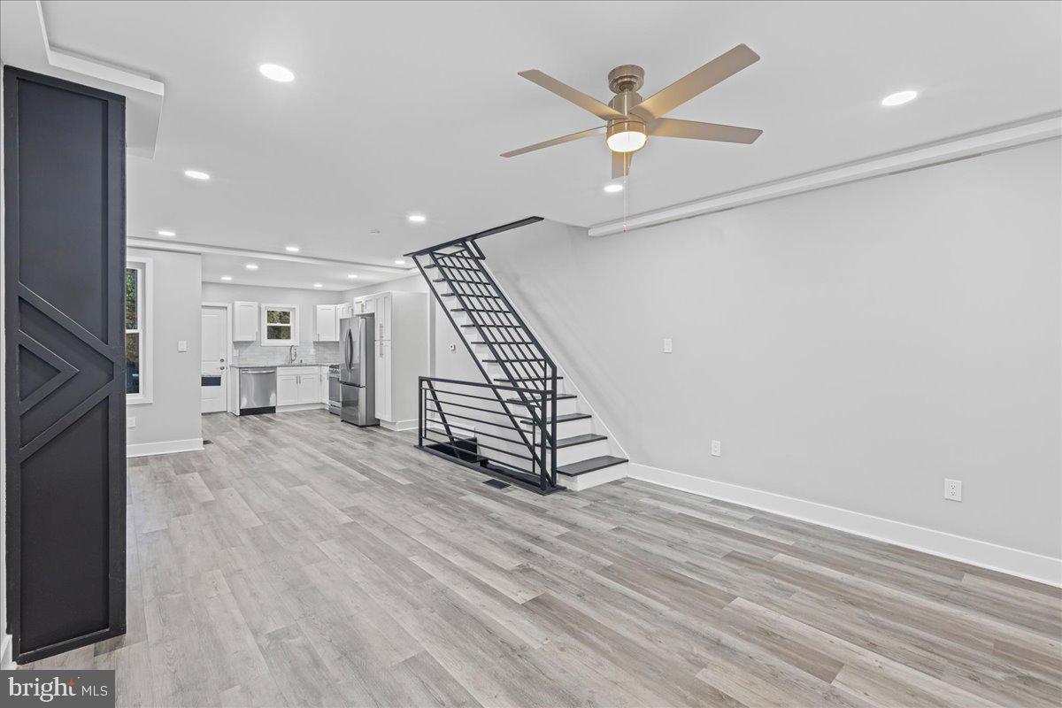 6629 Ross Street Philadelphia, PA 19119 - Photo 3 of 26 an empty room with wooden floor a ceiling fan and windows