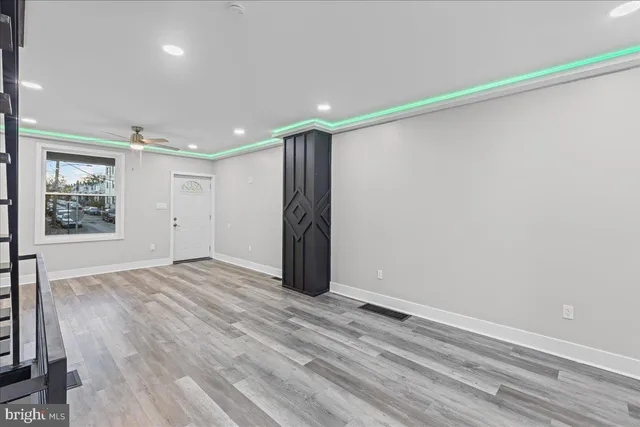 wooden floor in an empty room with a window