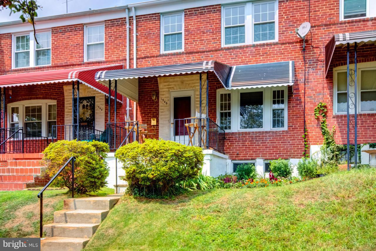 1546 Northbourne Road Baltimore, MD 21239 - Photo 2 of 18 front view of a brick building with a yard