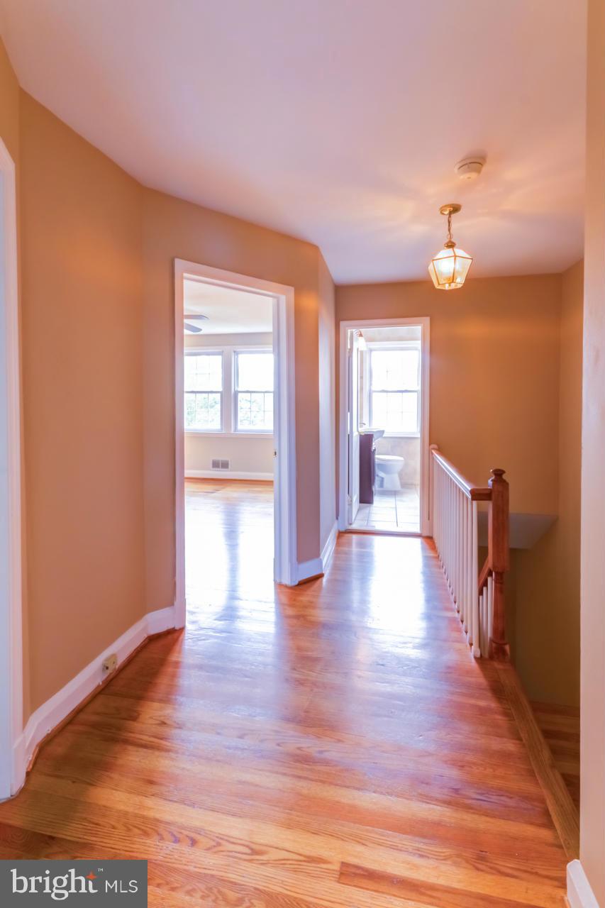 1546 Northbourne Road Baltimore, MD 21239 - Photo 14 of 18 a view of an empty room with wooden floor and a window