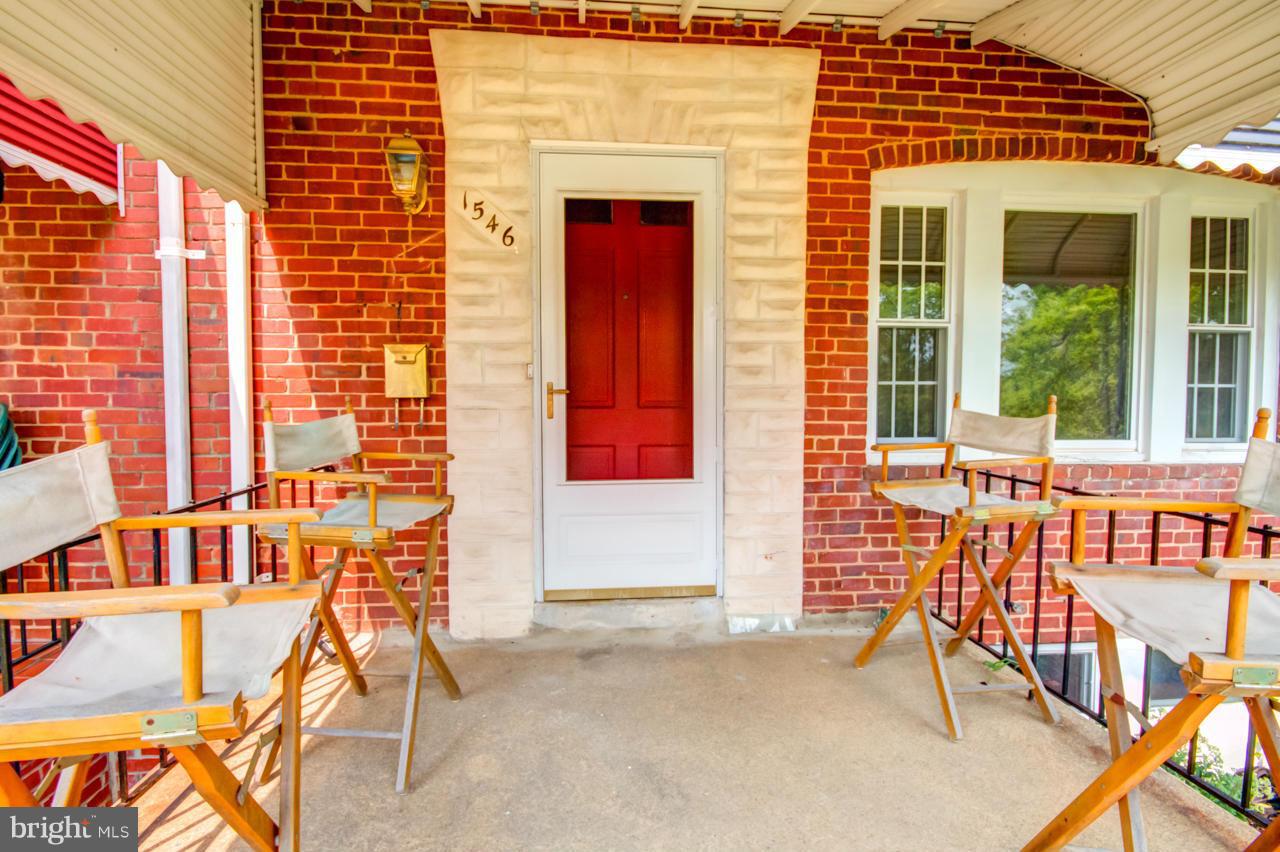 1546 Northbourne Road Baltimore, MD 21239 - Photo 3 of 18 a view of front door of house with outdoor seating