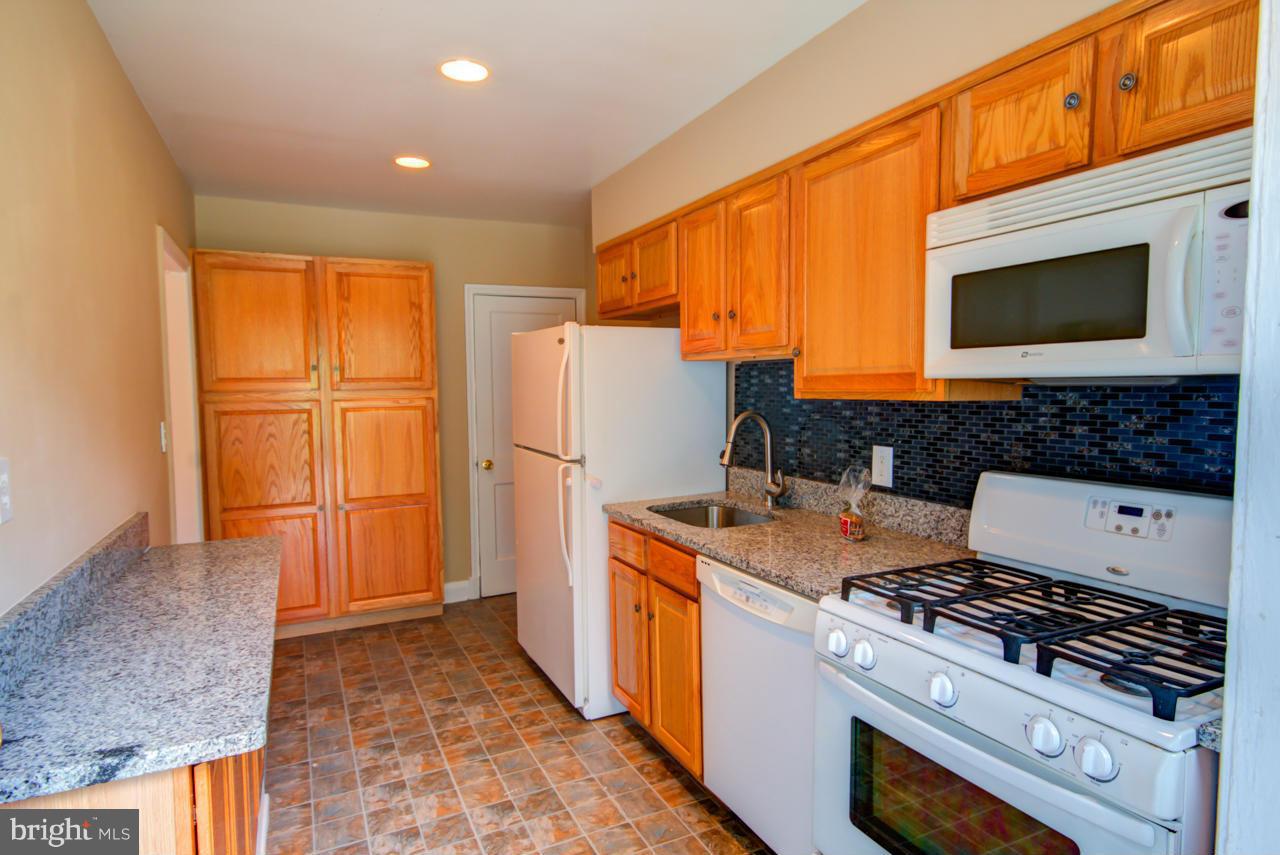 1546 Northbourne Road Baltimore, MD 21239 - Photo 4 of 18 a kitchen with stainless steel appliances granite countertop a stove a sink and a refrigerator