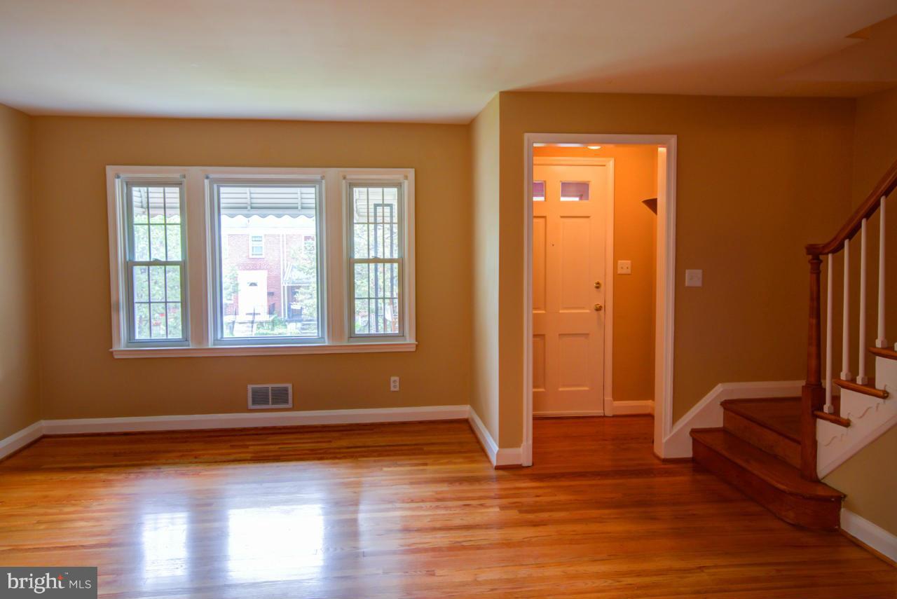 1546 Northbourne Road Baltimore, MD 21239 - Photo 5 of 18 a view of livingroom with hardwood floor and a window