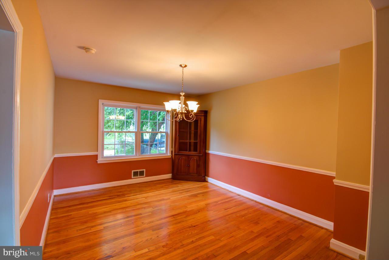 1546 Northbourne Road Baltimore, MD 21239 - Photo 8 of 18 a view of empty room with wooden floor and fan